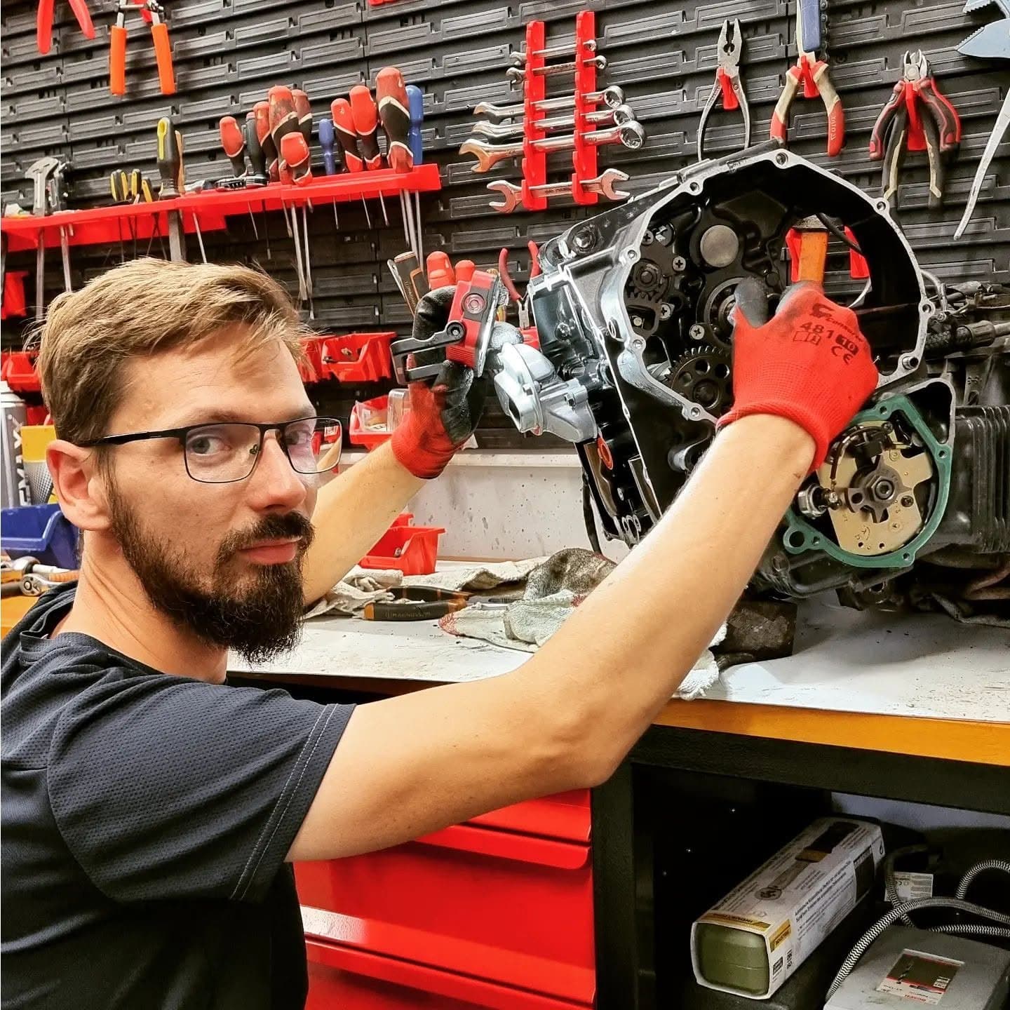Karol Małek, mechanik motocyklowy, przy rozebranym silniku w swoim warsztacie